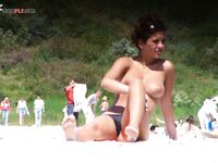 Quiet Topless Sunbathing by the Bright Blue Sea