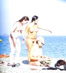 Walking Across Pebbles at a Nude Beach by Blue Sea