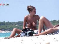 The joy of a topless swim in the clear, refreshing coastal waters. 2