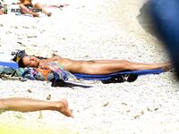. The artistic silhouette of a topless model against the sparkling blue sea. 6