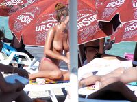 . The artistic silhouette of a topless model against the sparkling blue sea. 6