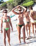 A woman enjoying the view of the waves in a relaxed topless state. 2