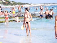 Walking around on a solitary strand while the wind caress her skin. 2