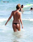 Walking around on a solitary strand while the wind caress her skin. 2