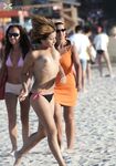 Her Long Braid Over One Shoulder Leaving the Shallow Surf