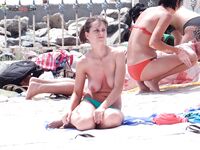 Her Long Braid Over One Shoulder Leaving the Shallow Surf