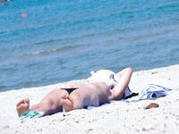 The artistic appeal of bare skin and white sand at a naturist retreat. 5