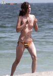 The liberation of a day at the beach with no tops and no social worries.