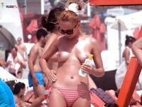 A model posing naturally among the grass dunes in a nude fashion. 6