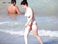 A model showcasing natural confidence during a bright, sun-soaked naturist session. 2