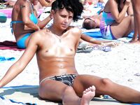 One Woman Topless on the Sand with Hoop Earrings