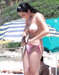 A relaxing session on a wooden pier, enjoying the heat in a European topless fashion.