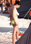 Posing with confidence and natural grace in a nude coastal setting. 6