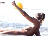 A topless lady watching the waves from a quiet, elevated coastal vantage point. 2