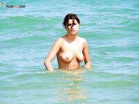 . Embracing a life without tan lines at a stunning, clothing-optional beach. 4