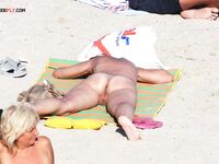 . Embracing a life without tan lines at a stunning, clothing-optional beach. 4