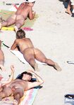 . Embracing a life without tan lines at a stunning, clothing-optional beach. 4