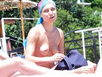 Oversized Shades Beside a Lifeguard Chair on a Quiet Topless Shore