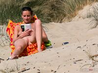 topless beach visitor enjoying sunshine