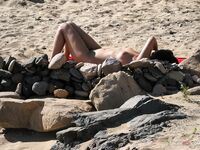 topless beach scene with sea view