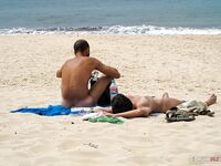 topless beach scene with sea view