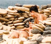 topless beach vacationer walking