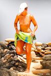 Quiet Topless Moment on a Rocky Shoreline
