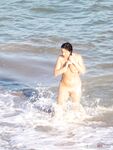 Laughing Together in the Foamy Surf at a Nude Beach