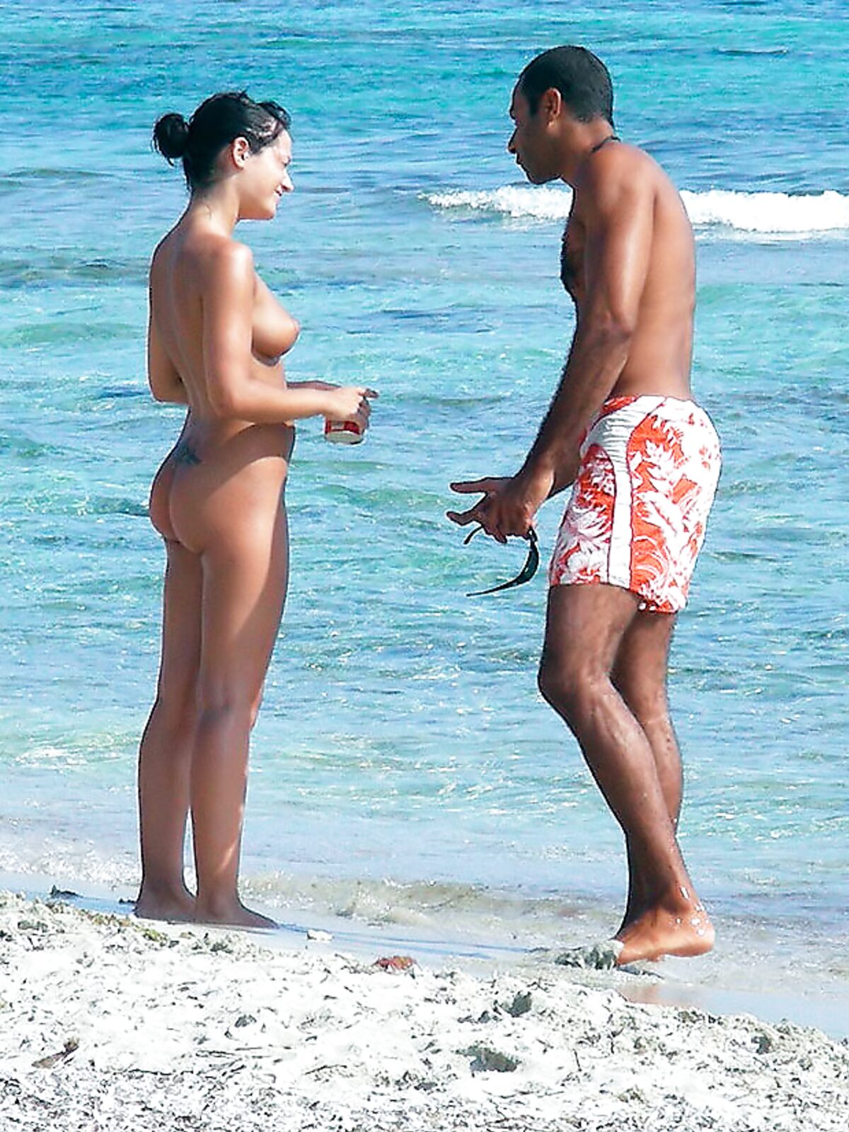 Dazzling blonde with a slim body and small tits walks around the beach topless 2 album preview