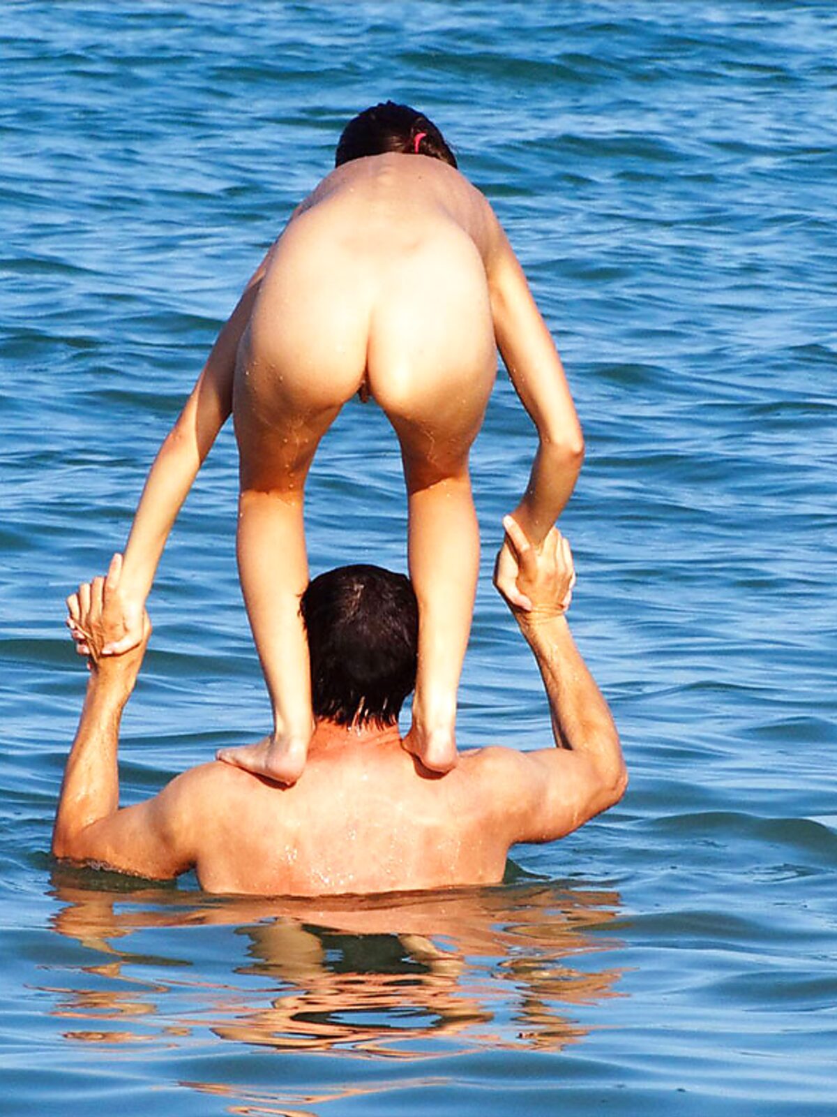 The natural beauty of a lady sunbathing topless on a quiet, sunny pier. album preview