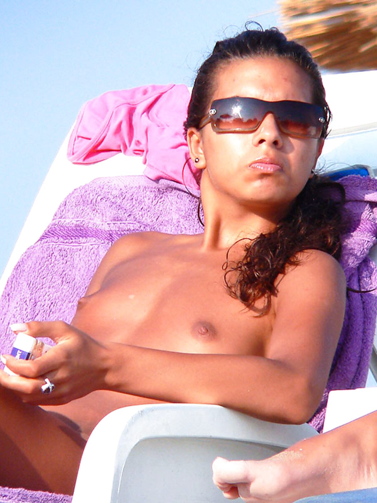 Lounging Topless on a Sandy Beach Chair With a Purple Towel album preview