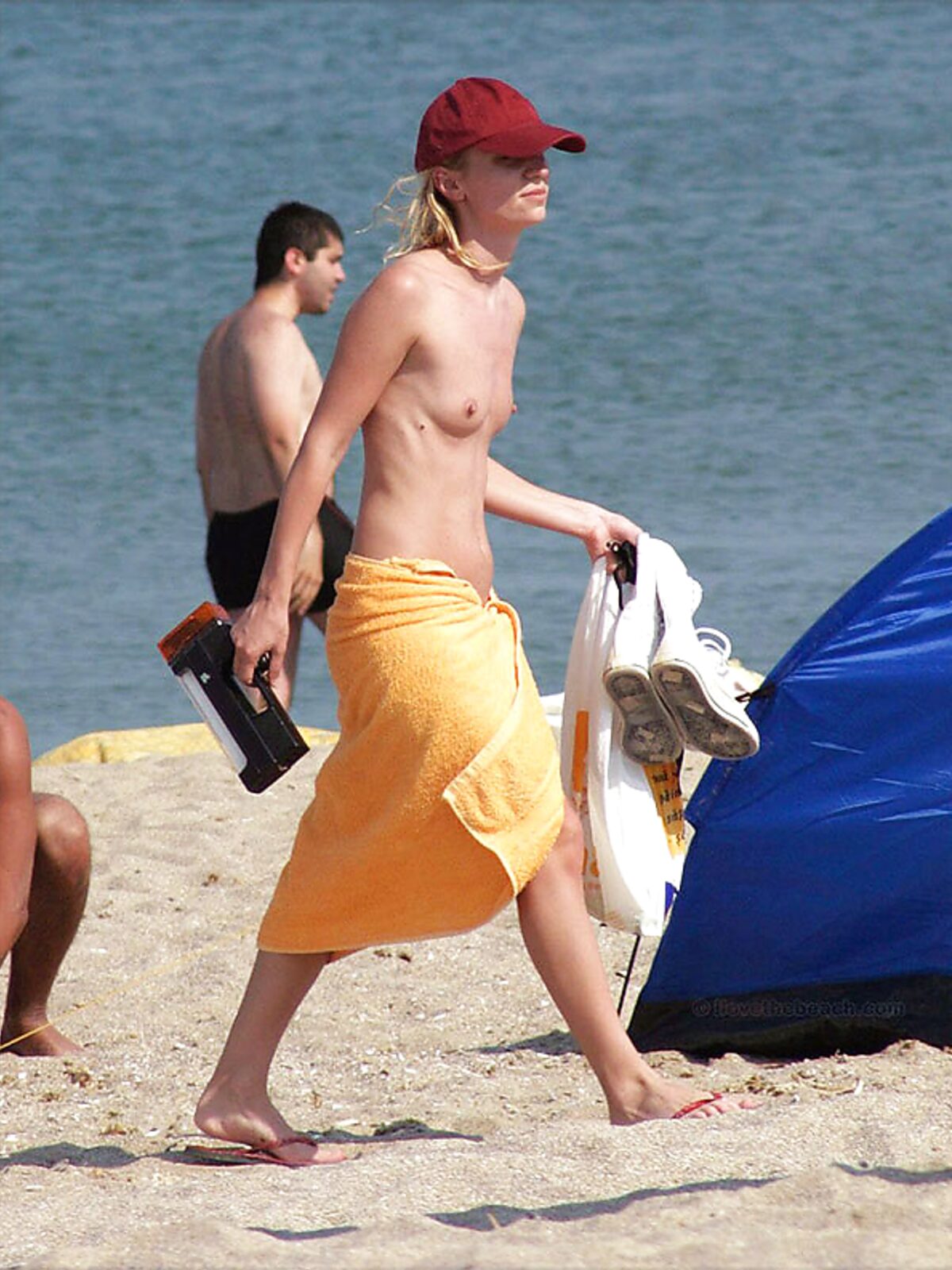 . A lady absorbed in the scenery while enjoying the warm rays in a relaxed topless fashion. album preview