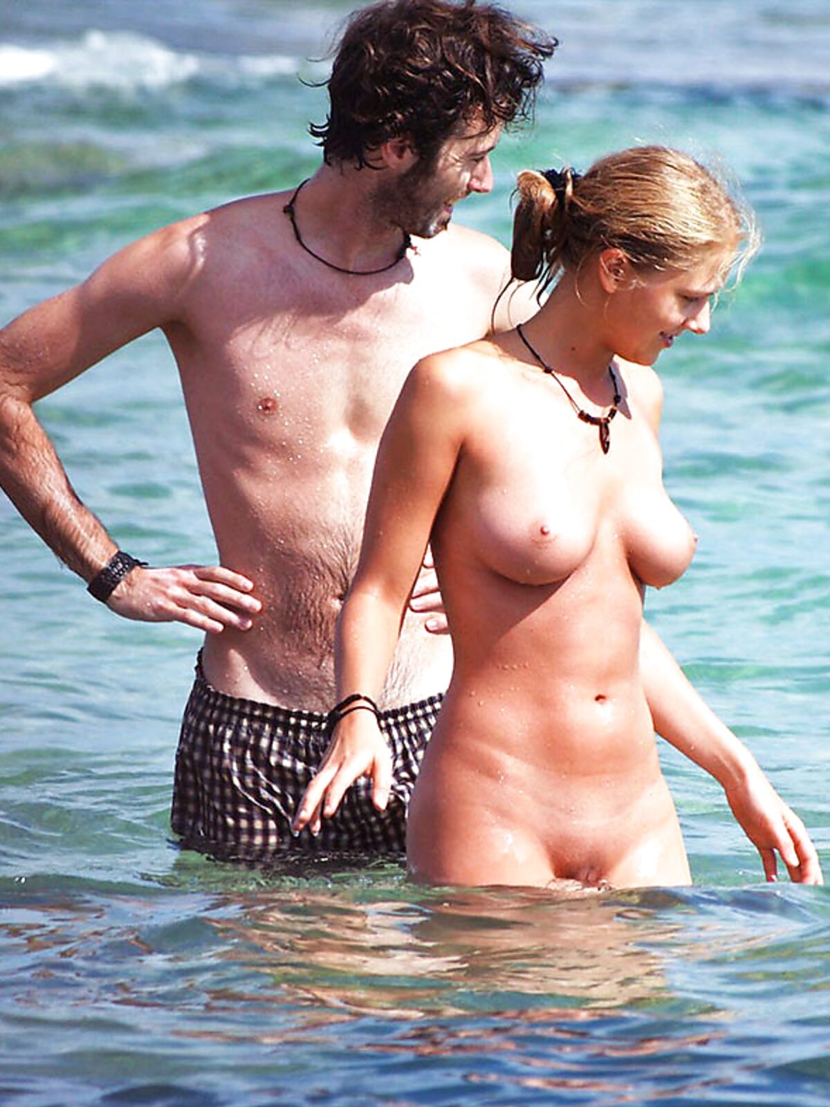 Two Naturists Pause Mid-Wade in Calm Shallow Sea Water album preview