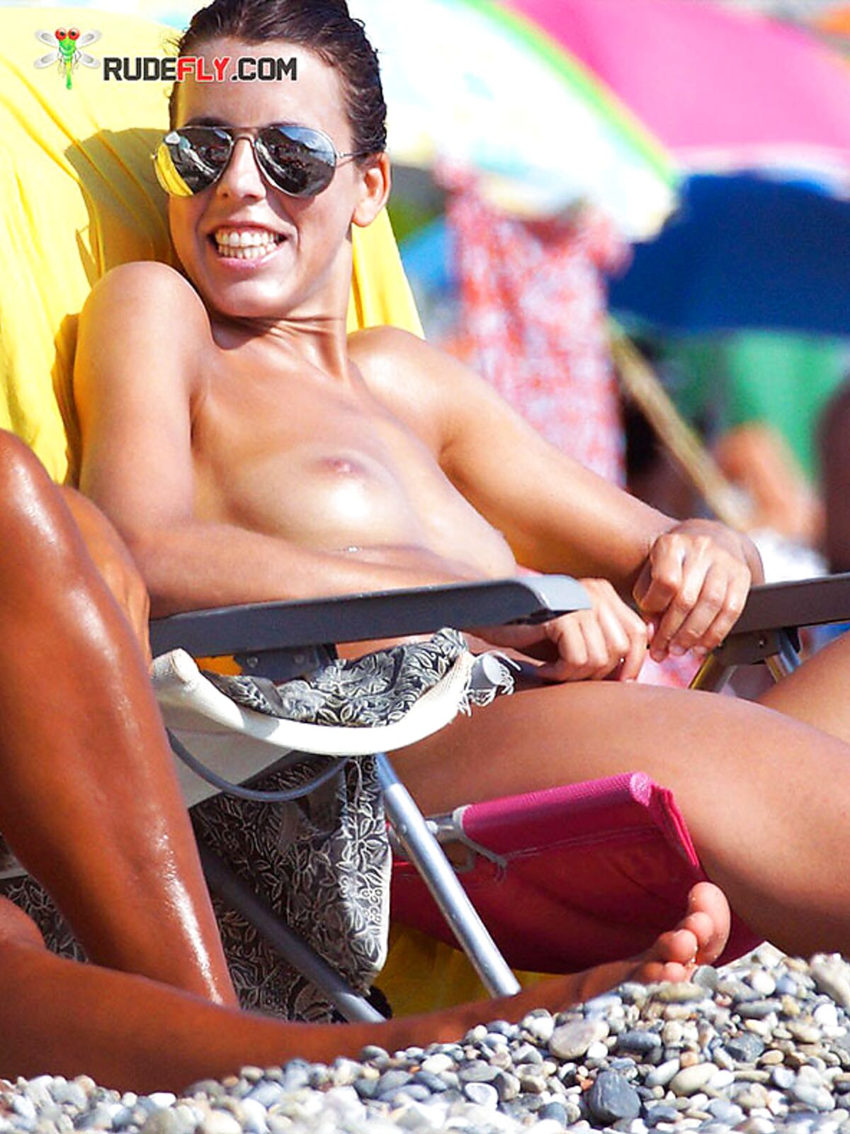 A lady enjoying a cold drink while sunbathing topless on the warm shore. 3 album preview