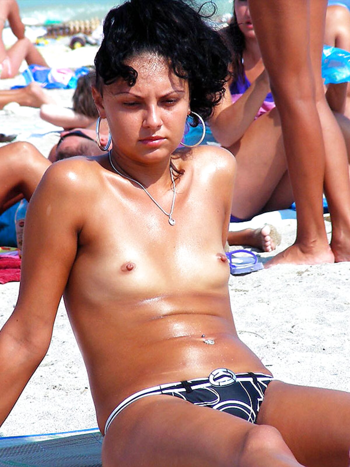 One Woman Topless on the Sand with Hoop Earrings album preview