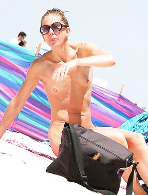 Sitting by a Black Bag at a Nude Beach