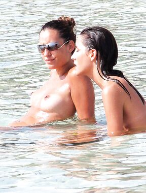 . The artistic silhouette of a topless model against the sparkling blue sea. 2