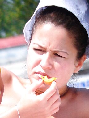 Sun Hat, Bright Light, and a Bite of Orange Outdoors